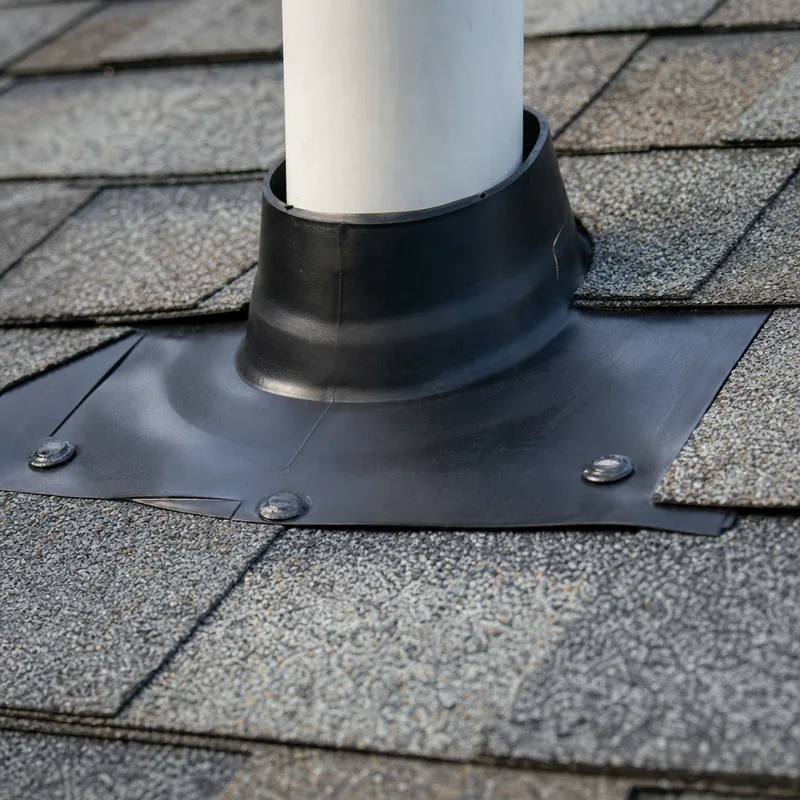 New pipe boot correctly seated beneath shingles with flashing and sealed nail heads